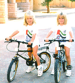 Alice and Lucy on their bikes in our compound.